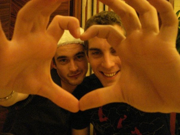 Two people making a heart shape with their fingers
